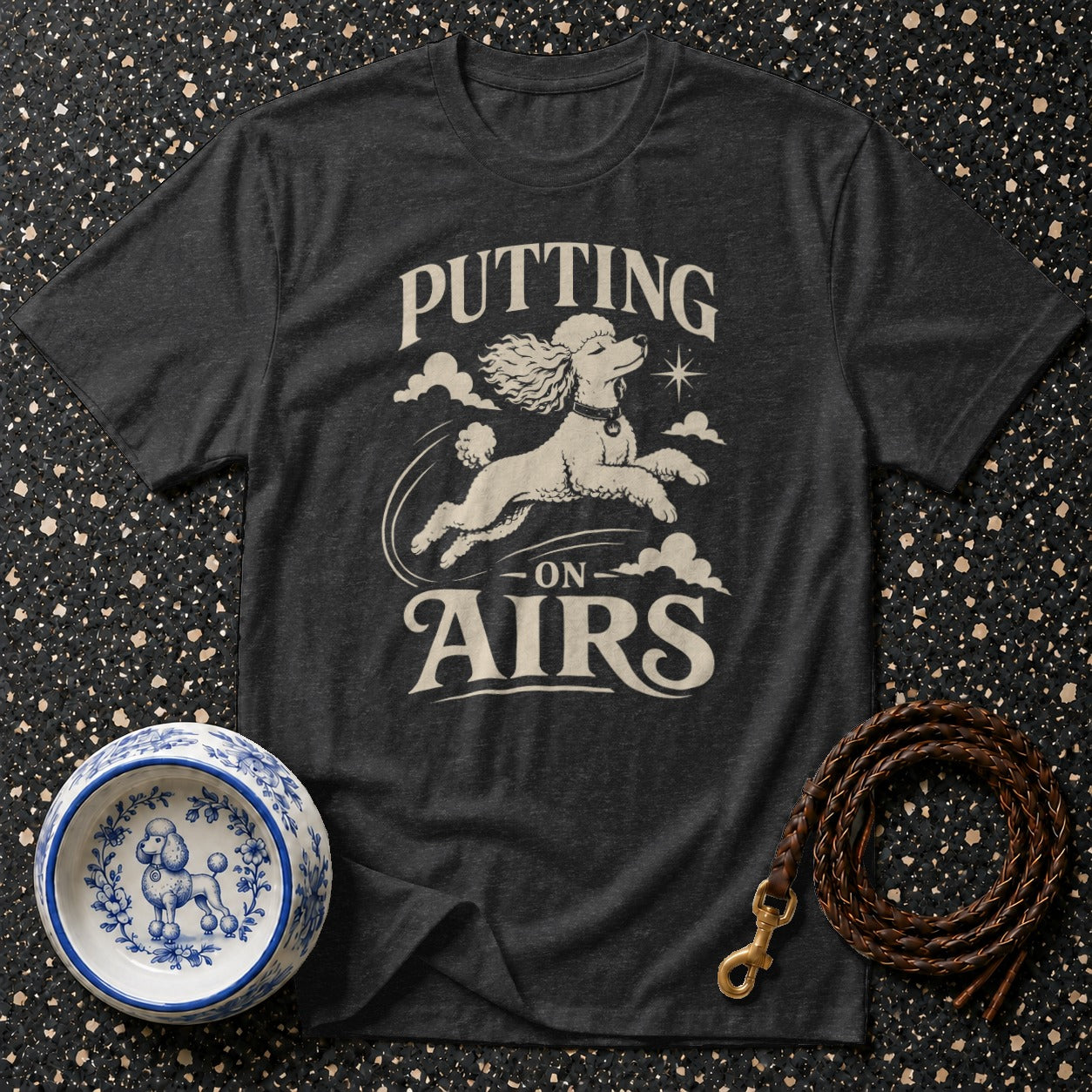 Dark grey t-shirt with poodle graphic and text "PUTTING ON AIRS"