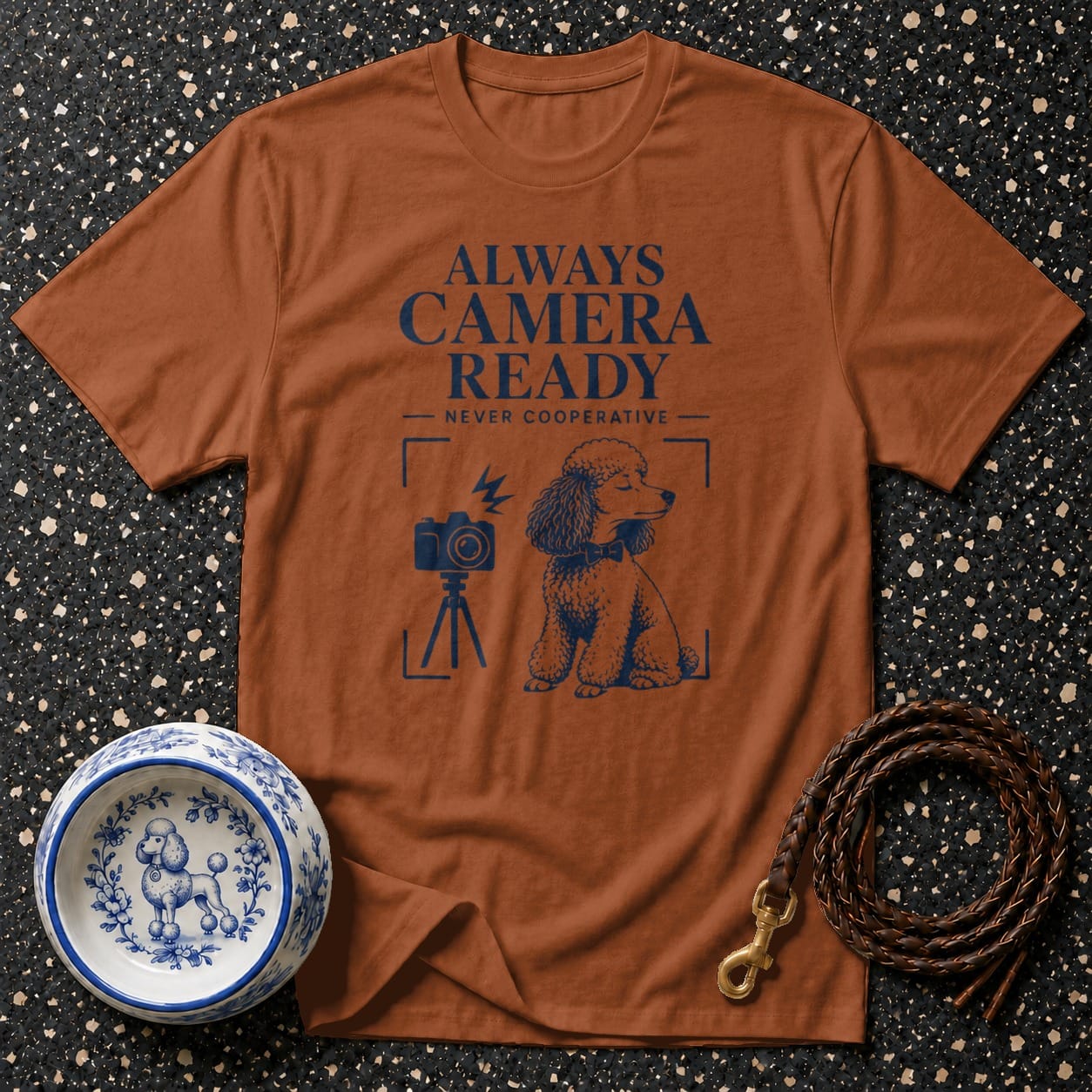 Brown t-shirt with navy print "ALWAYS CAMERA READY NEVER COOPERATIVE" and a poodle.