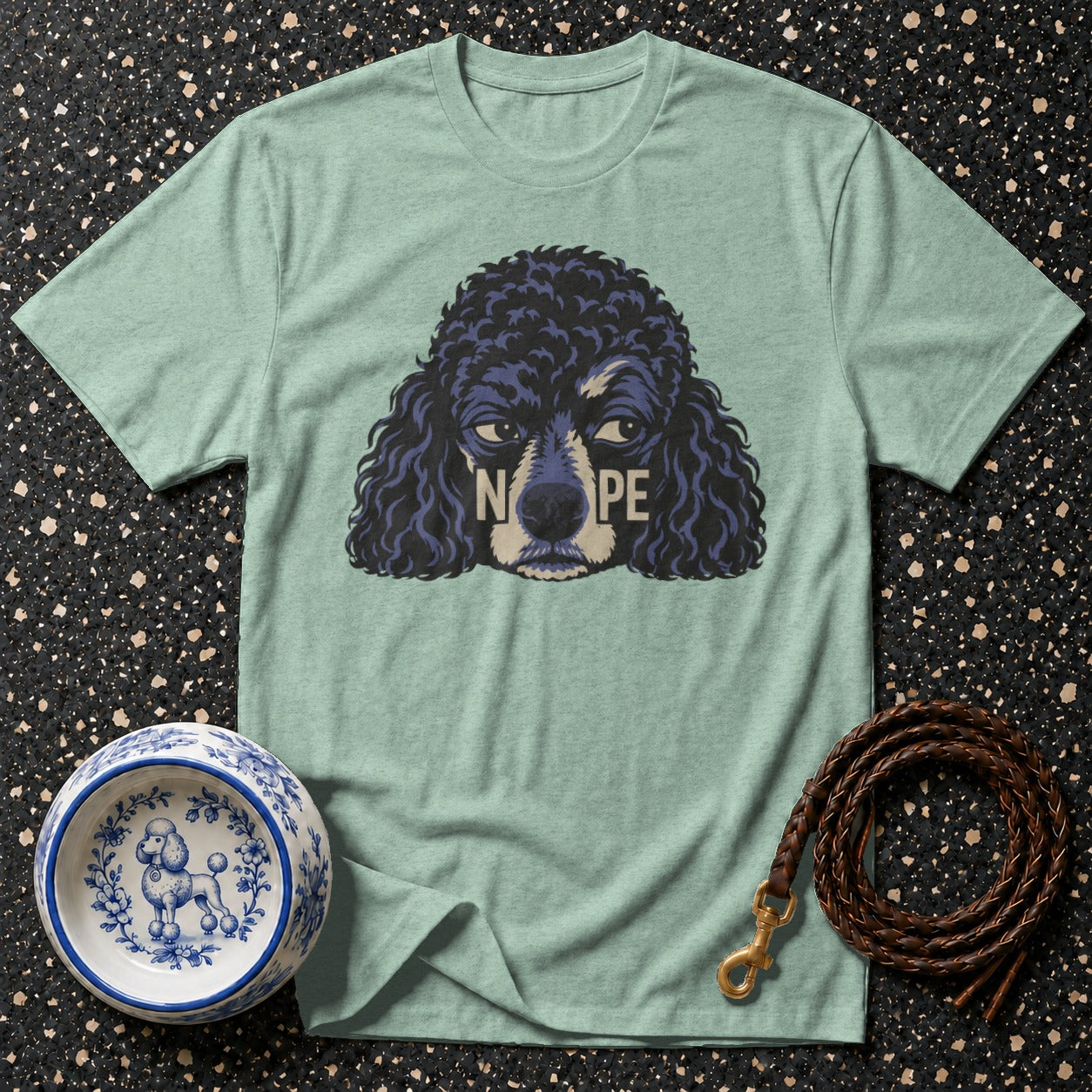 Light mint t-shirt with a dark poodle graphic reading "NOPE" and a patterned dog bowl.
