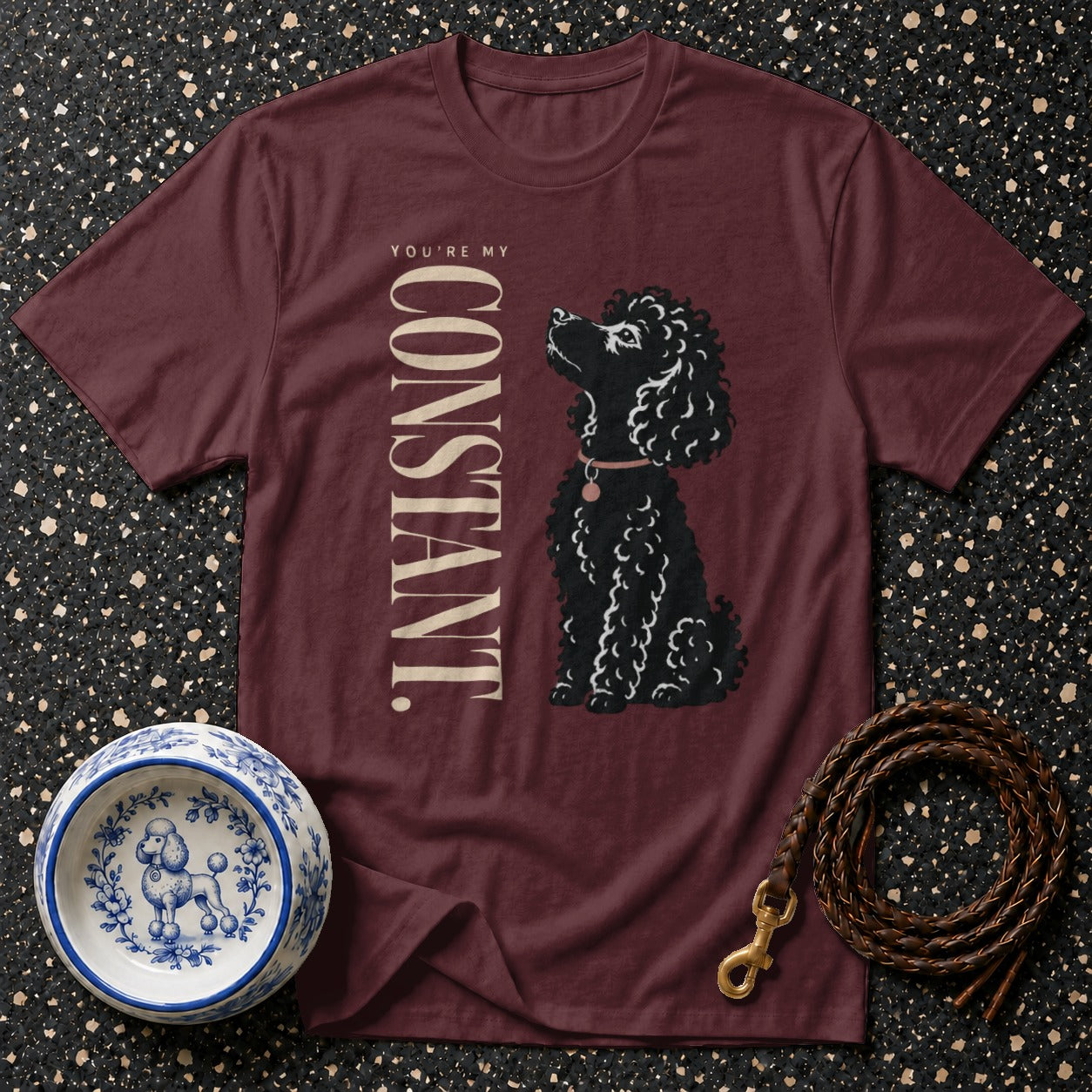 Maroon t-shirt with black poodle illustration and text "YOU'RE MY CONSTANT."