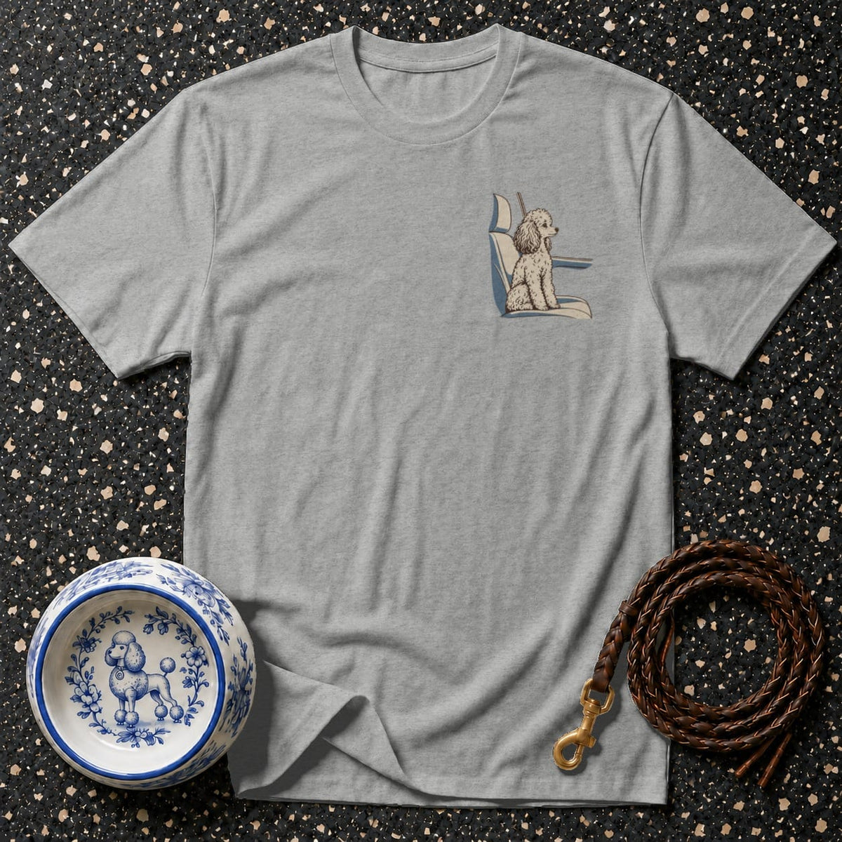 Grey t-shirt with a poodle graphic on the pocket, a decorative dog bowl, and a leash.