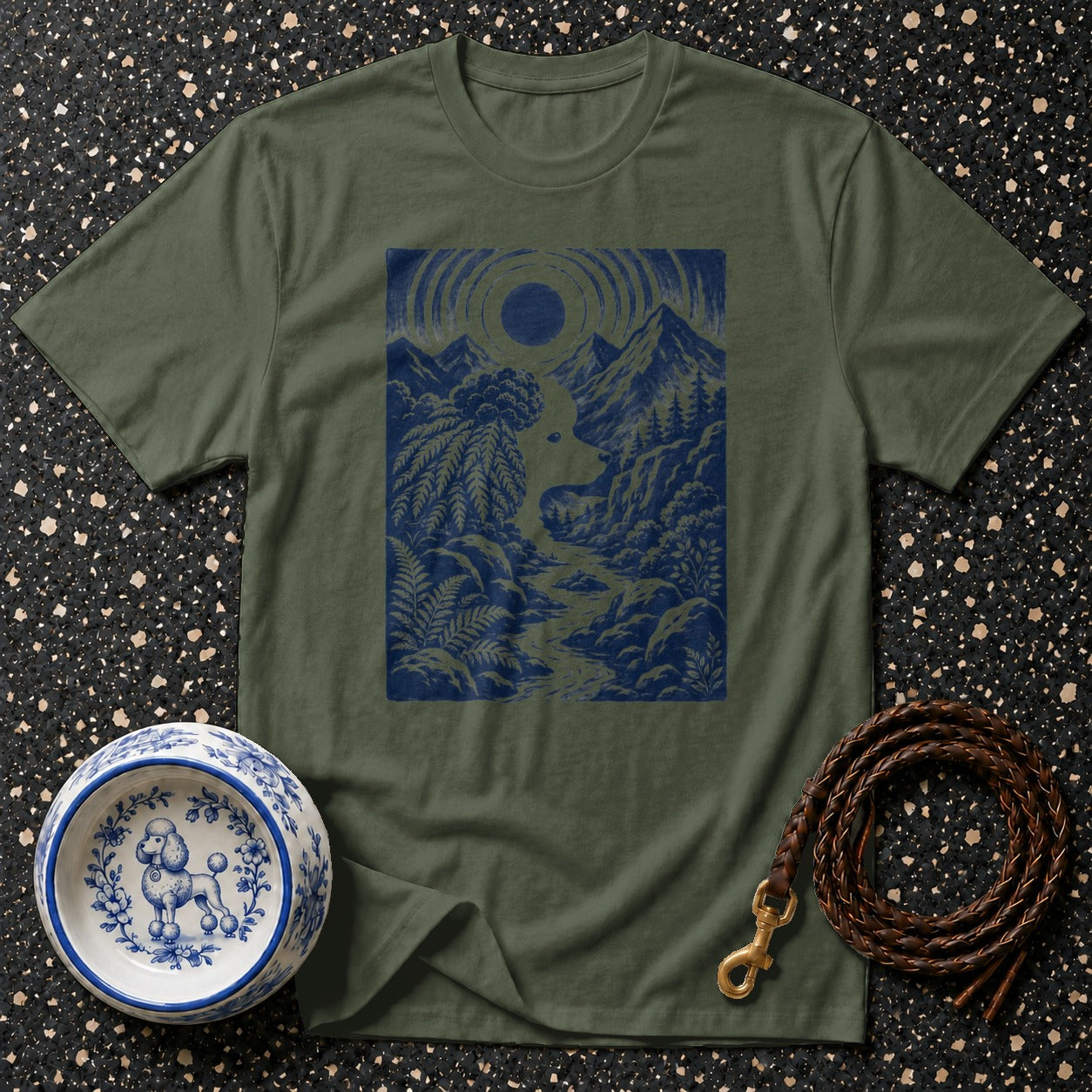 Olive green t-shirt with a blue mountain landscape and sun graphic.