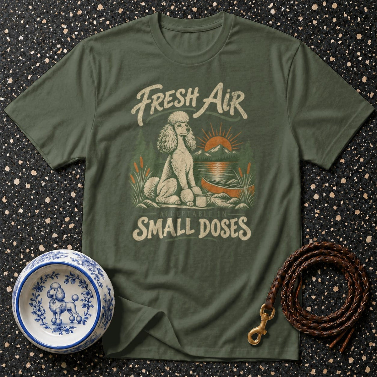 Green t-shirt with poodle, campfire, lake, and mountains graphic reading "Fresh Air Acceptable in Small Doses."