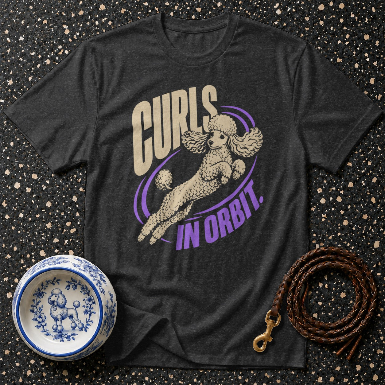 Dark grey t-shirt with a poodle graphic and text "Curls In Orbit."