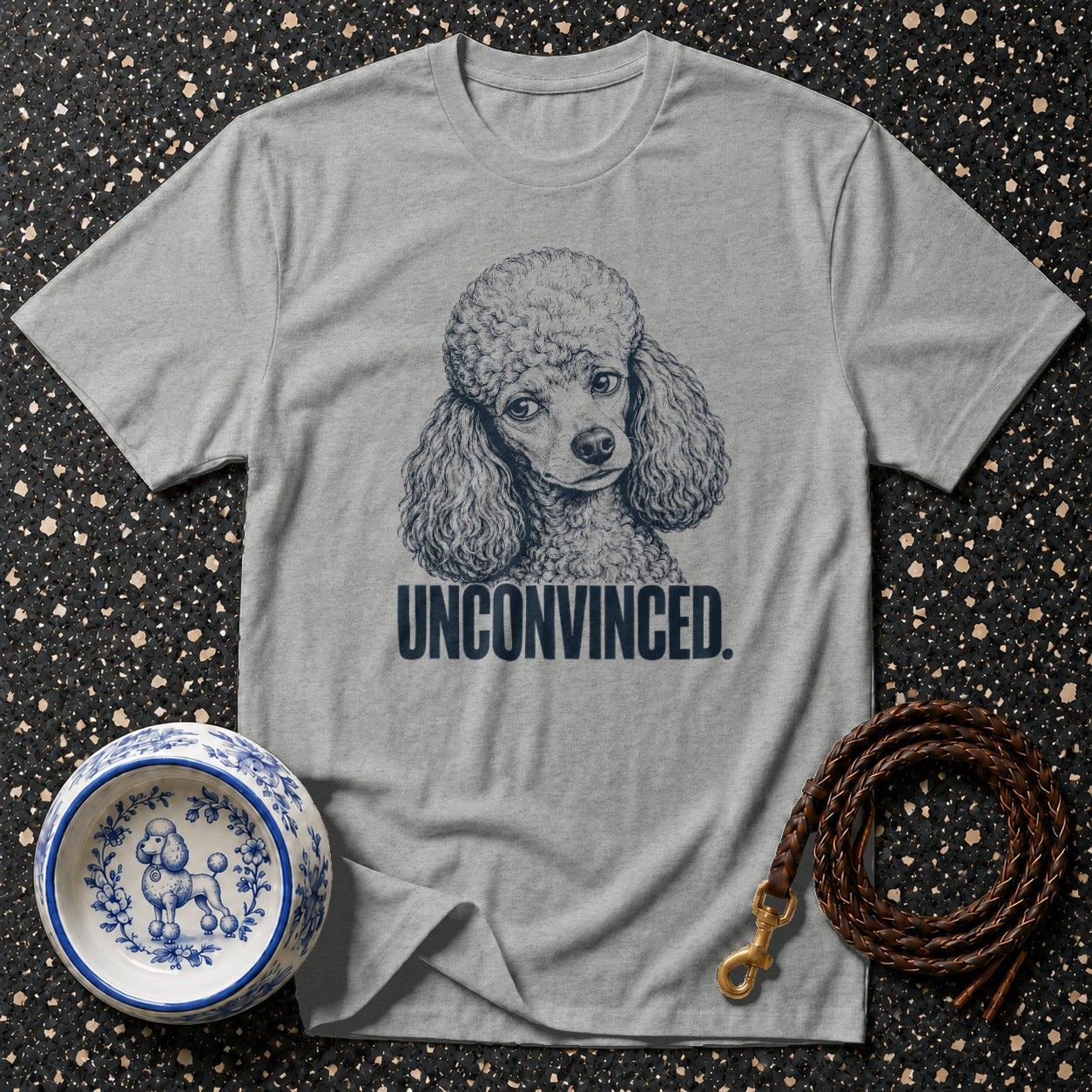 Grey t-shirt with a poodle drawing and "UNCONVINCED." text.