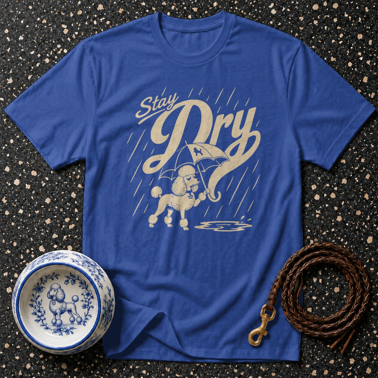 Blue t-shirt with "Stay Dry" text and poodle holding umbrella in rain graphic.