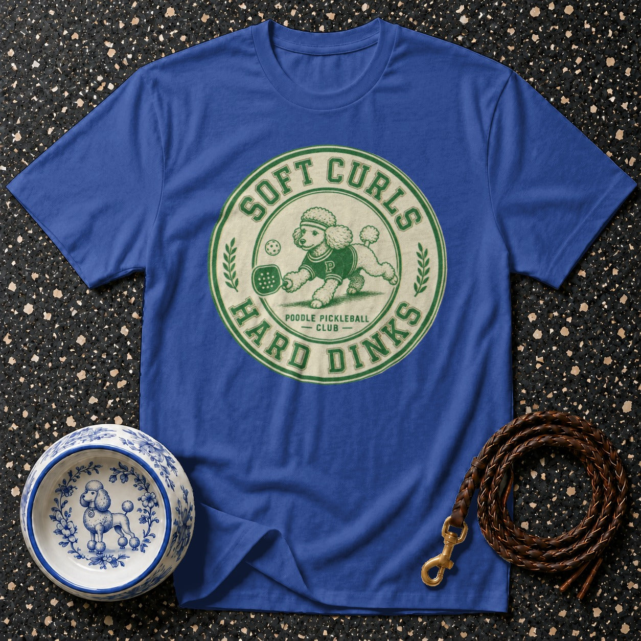 Blue t-shirt with "Soft Curls Hard Dinks Poodle Pickleball Club" graphic.