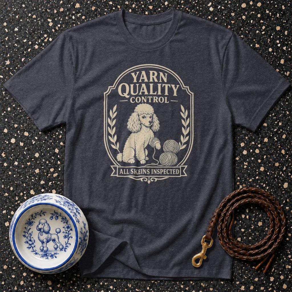 Dark t-shirt with a cream graphic of a poodle inspecting yarn skeins.
