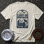 White t-shirt with a poodle in a carrier graphic that reads "CARRY-ON WITH STRONG OPINIONS".