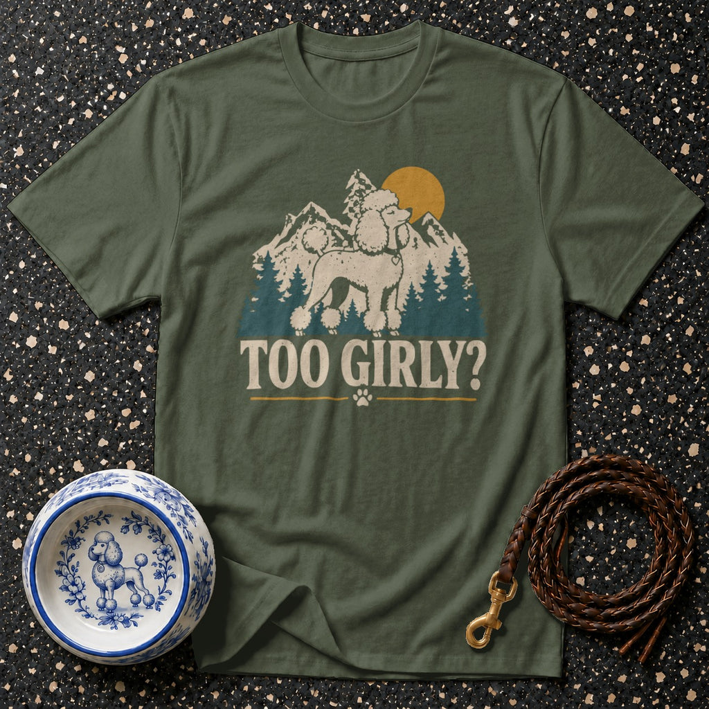 Green t-shirt with poodle, mountains, sun graphic and "Too Girly?" text.