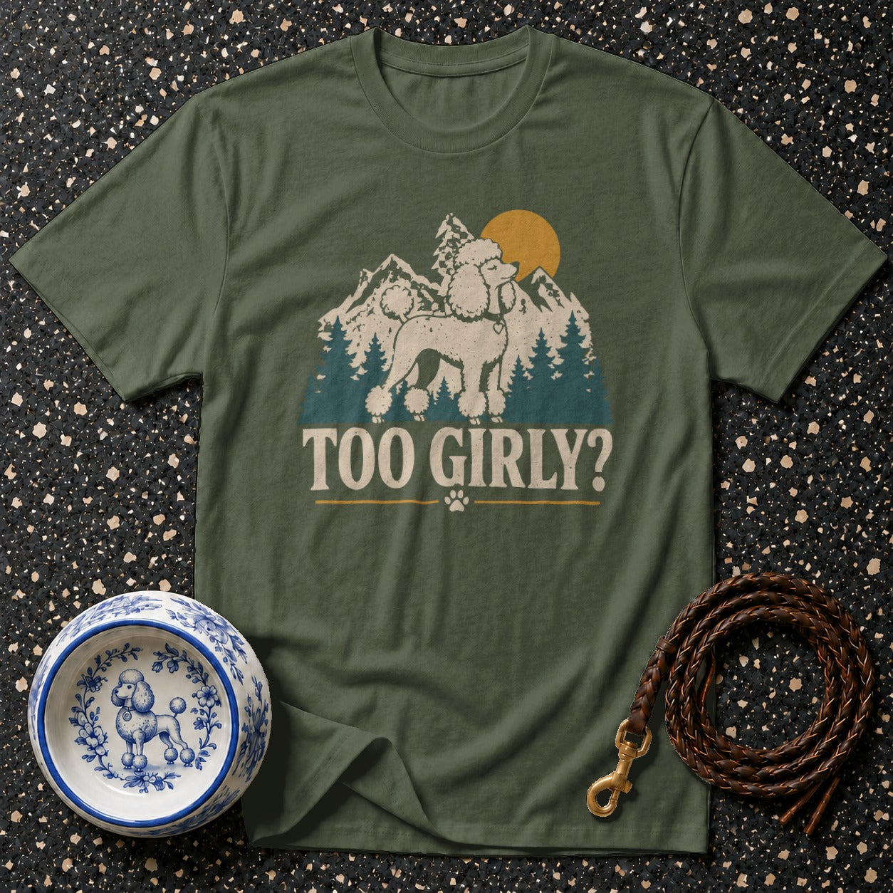 Green t-shirt with poodle, mountains, sun graphic and "Too Girly?" text.