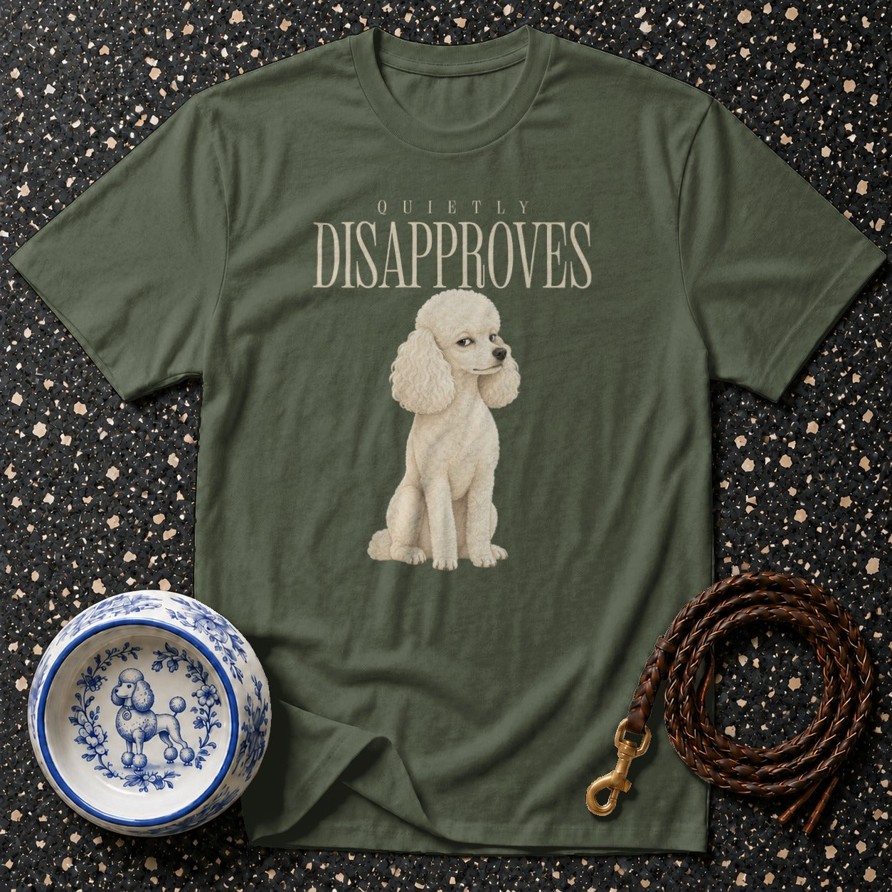 Olive t-shirt with a white poodle and "QUIETLY DISAPPROVES" text.