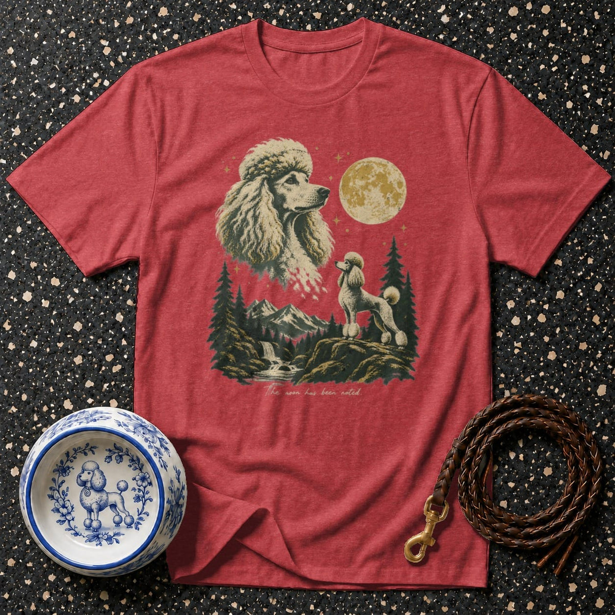 Red t-shirt with poodle graphic, mountain scene, full moon, and text "The moon has been noted."