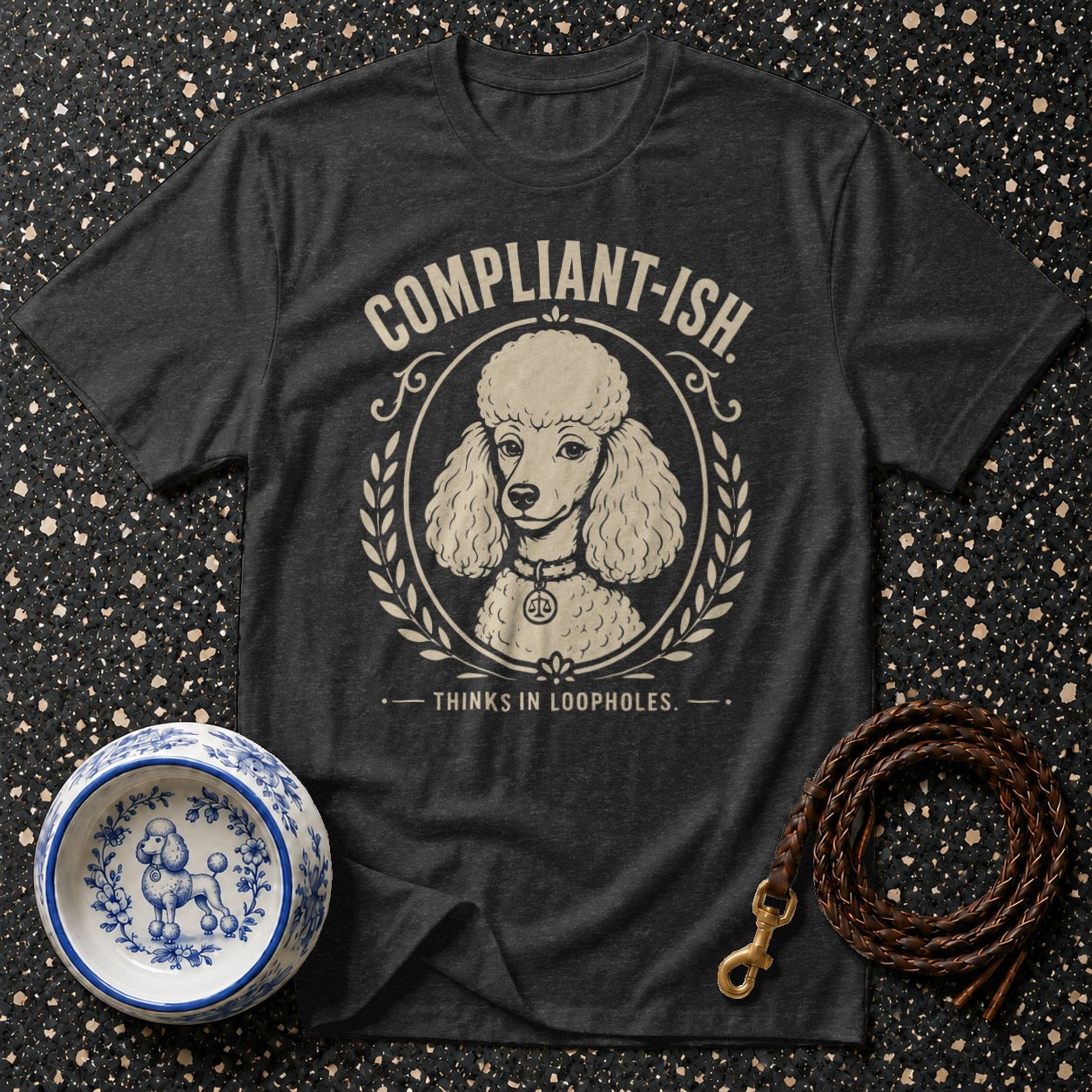 Dark grey t-shirt with a poodle graphic and text "COMPLIANT-ISH. THINKS IN LOOPHOLES."
