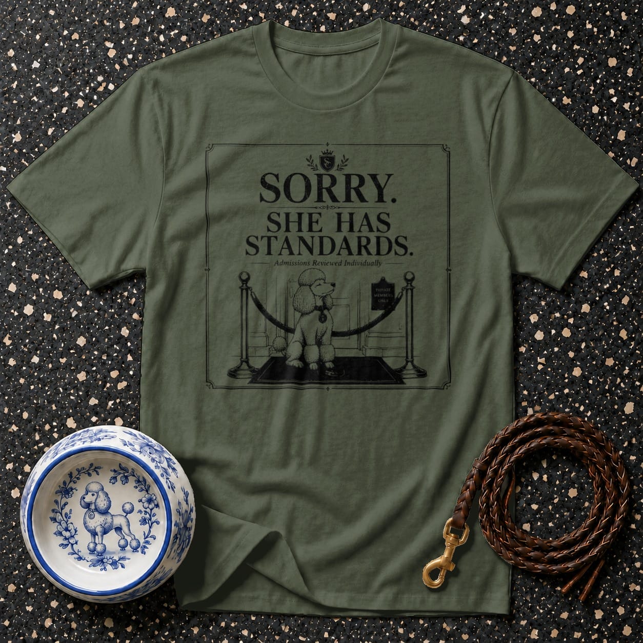 Olive green t-shirt with a graphic of a poodle and text saying "Sorry. She has standards."