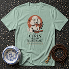 Light blue t-shirt with poodle illustration and text "The Curls Require Maintenance."
