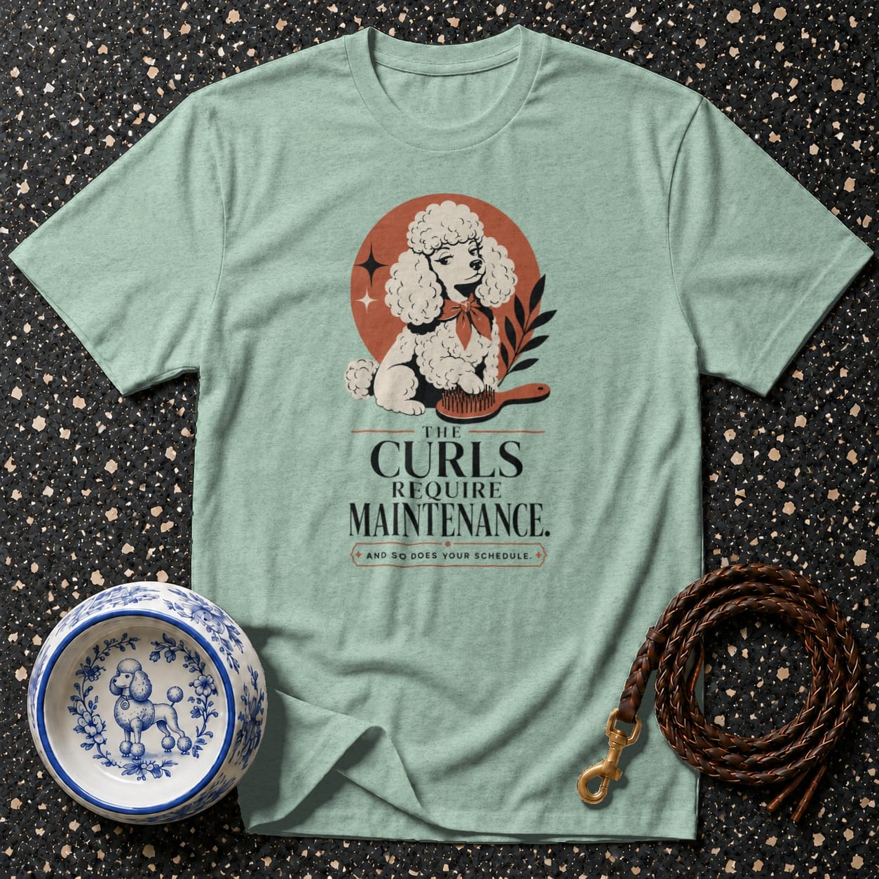 Light blue t-shirt with poodle illustration and text "The Curls Require Maintenance."