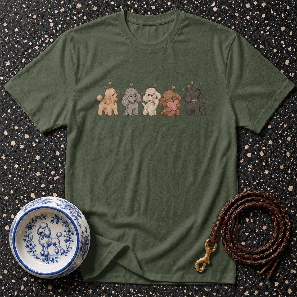 Green t-shirt with illustration of five toy poodles and a decorative dog bowl.