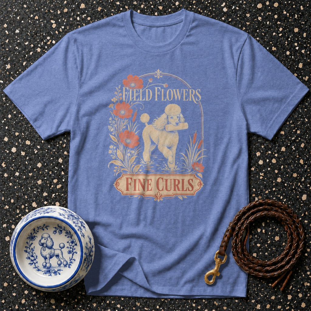 Blue t-shirt with poodle, flowers, and text "FIELD FLOWERS FINE CURLS".