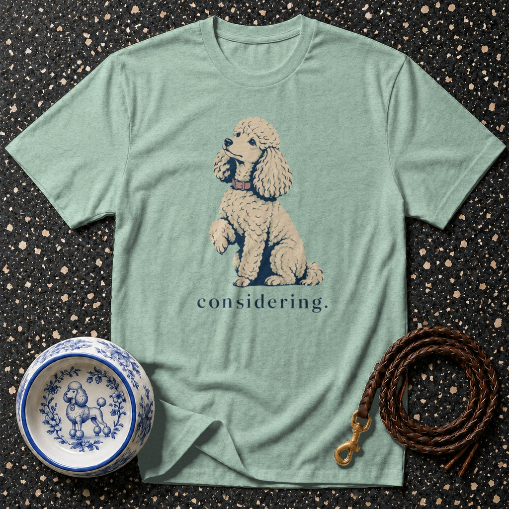 Light blue t-shirt with a poodle graphic and the word "considering."
