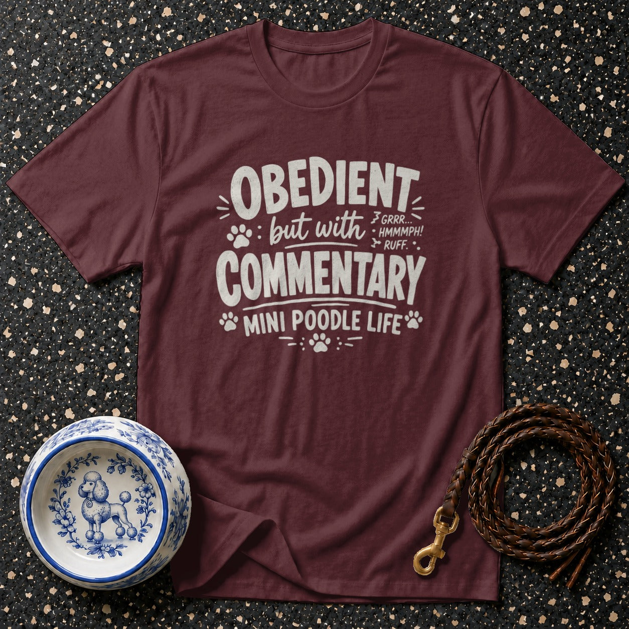Maroon t-shirt with "Obedient but with Commentary" and poodle graphics.