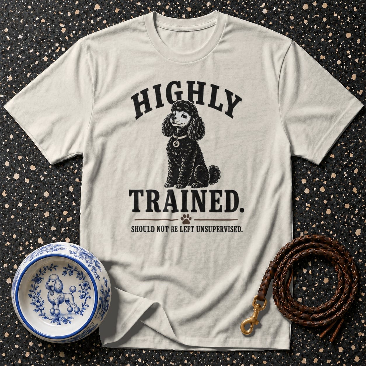 Cream t-shirt with "HIGHLY TRAINED. SHOULD NOT BE LEFT UNSUPERVISED." and a poodle graphic.