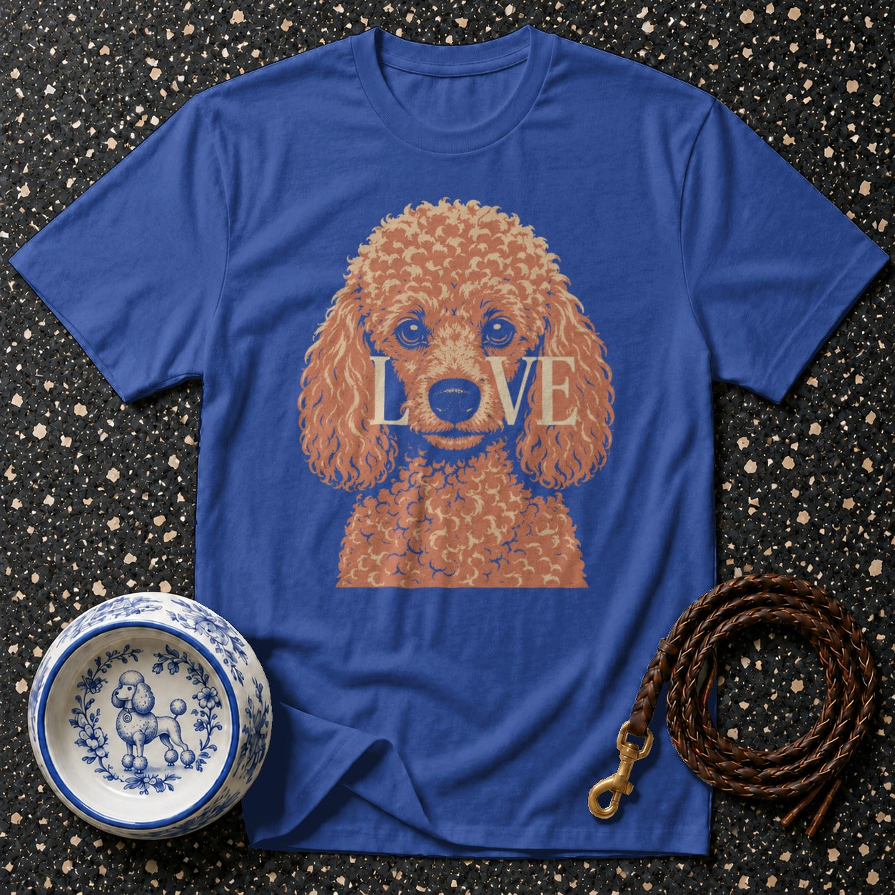 Blue t-shirt with poodle graphic and "LOVE" text, next to a dog bowl and leash.