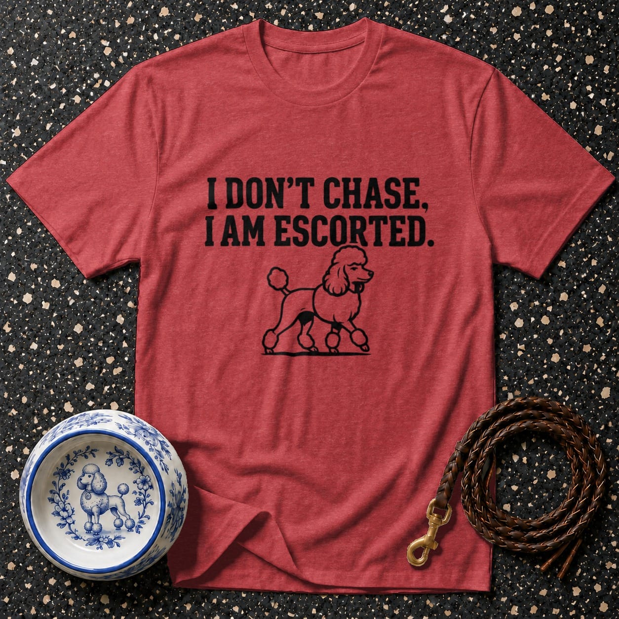 Red t-shirt with black text "I DON'T CHASE, I AM ESCORTED" and a poodle graphic.