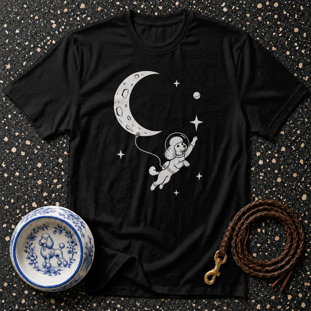 Black t-shirt with a poodle astronaut floating near a crescent moon and stars.