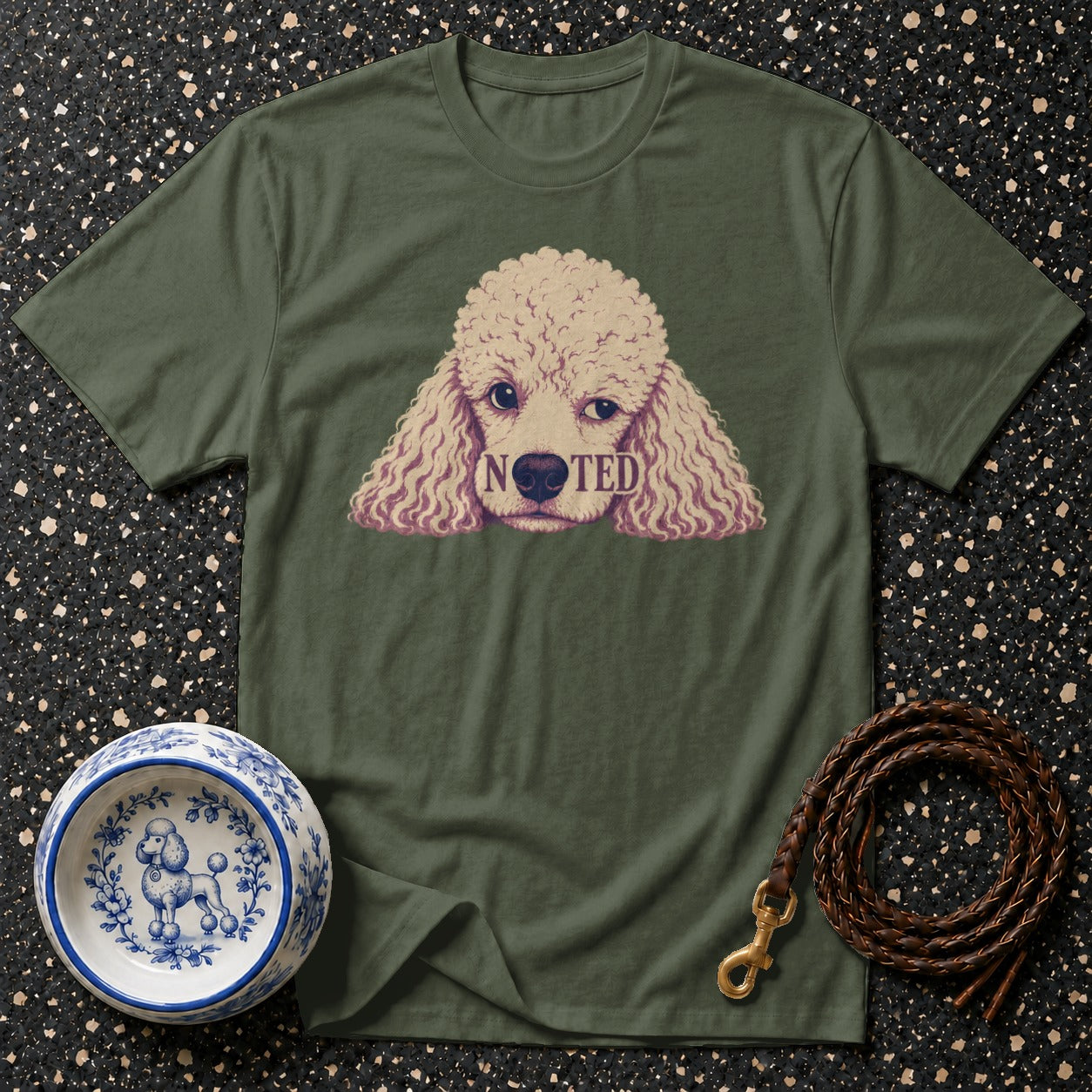 Green t-shirt with poodle graphic and the word "NOTED".