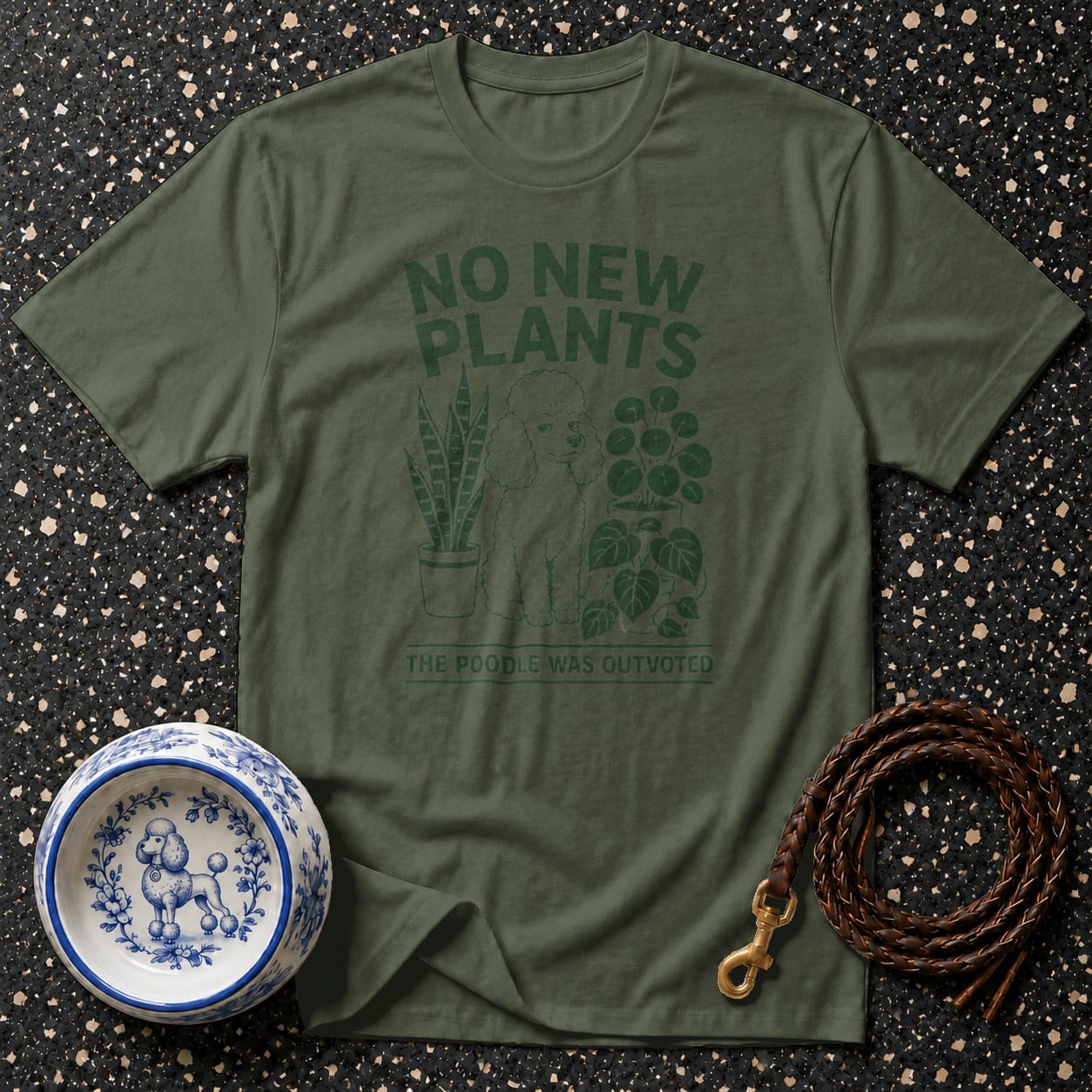 Olive green t-shirt with "No New Plants The Poodle Was Outvoted" text and poodle graphic.