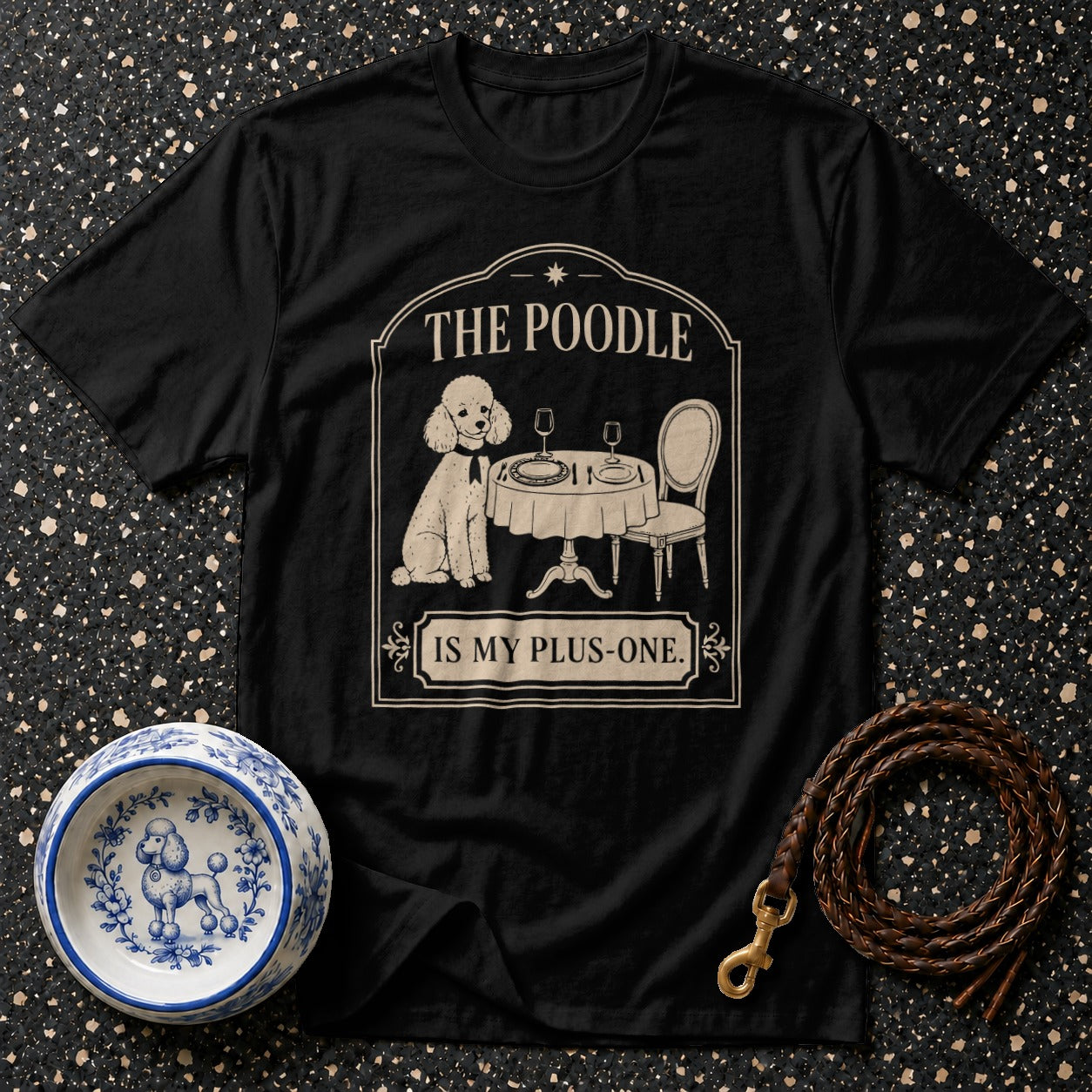 Black t-shirt with a poodle sitting at a table with text "THE POODLE IS MY PLUS-ONE."