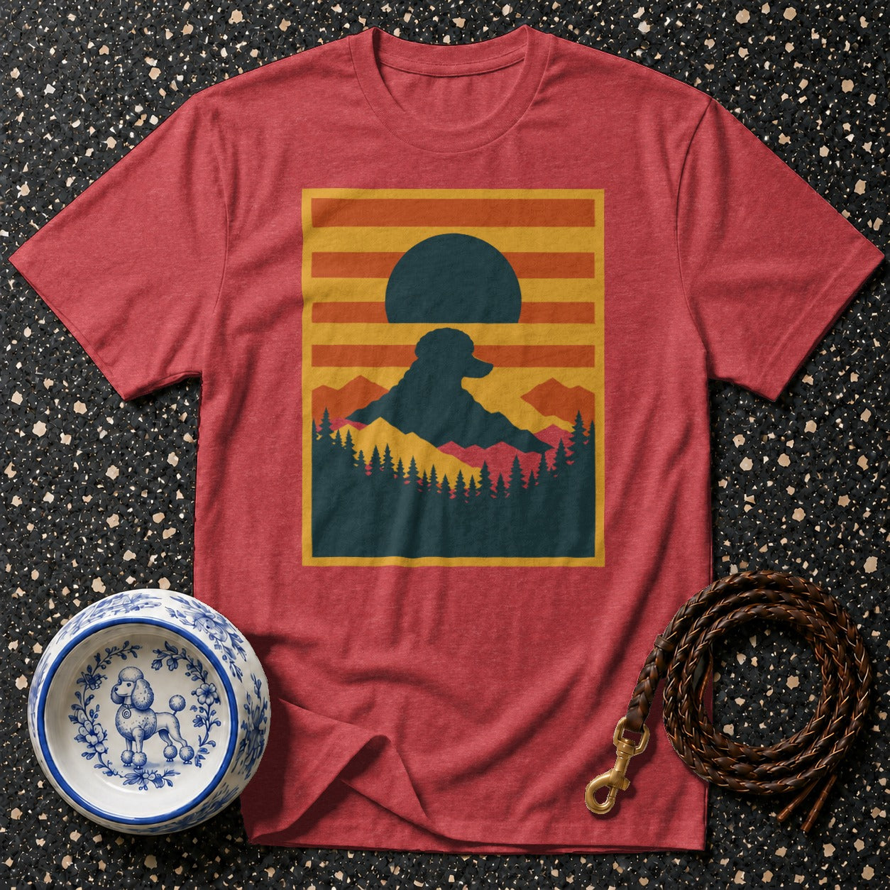 Red t-shirt with a mountain landscape and poodle silhouette graphic.