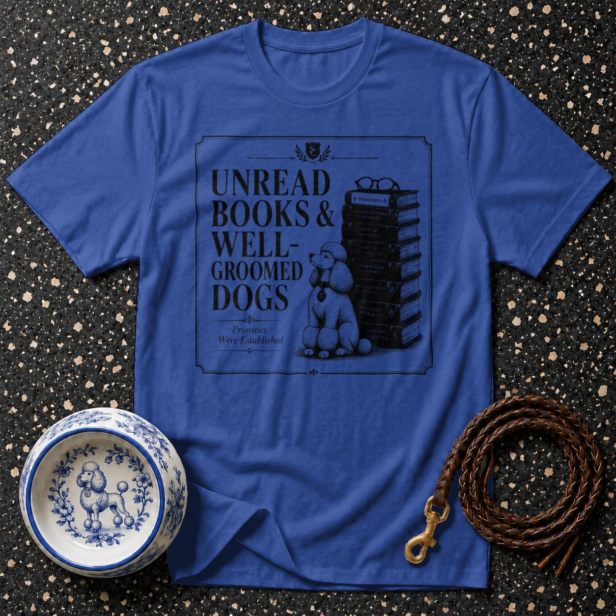 Blue t-shirt with "Unread Books & Well-Groomed Dogs" text and poodle illustration.