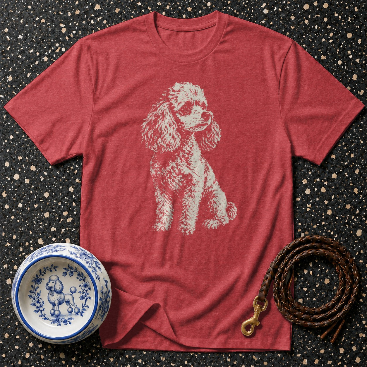 Red t-shirt with sketch of white poodle, blue and white poodle bowl, and braided leash.