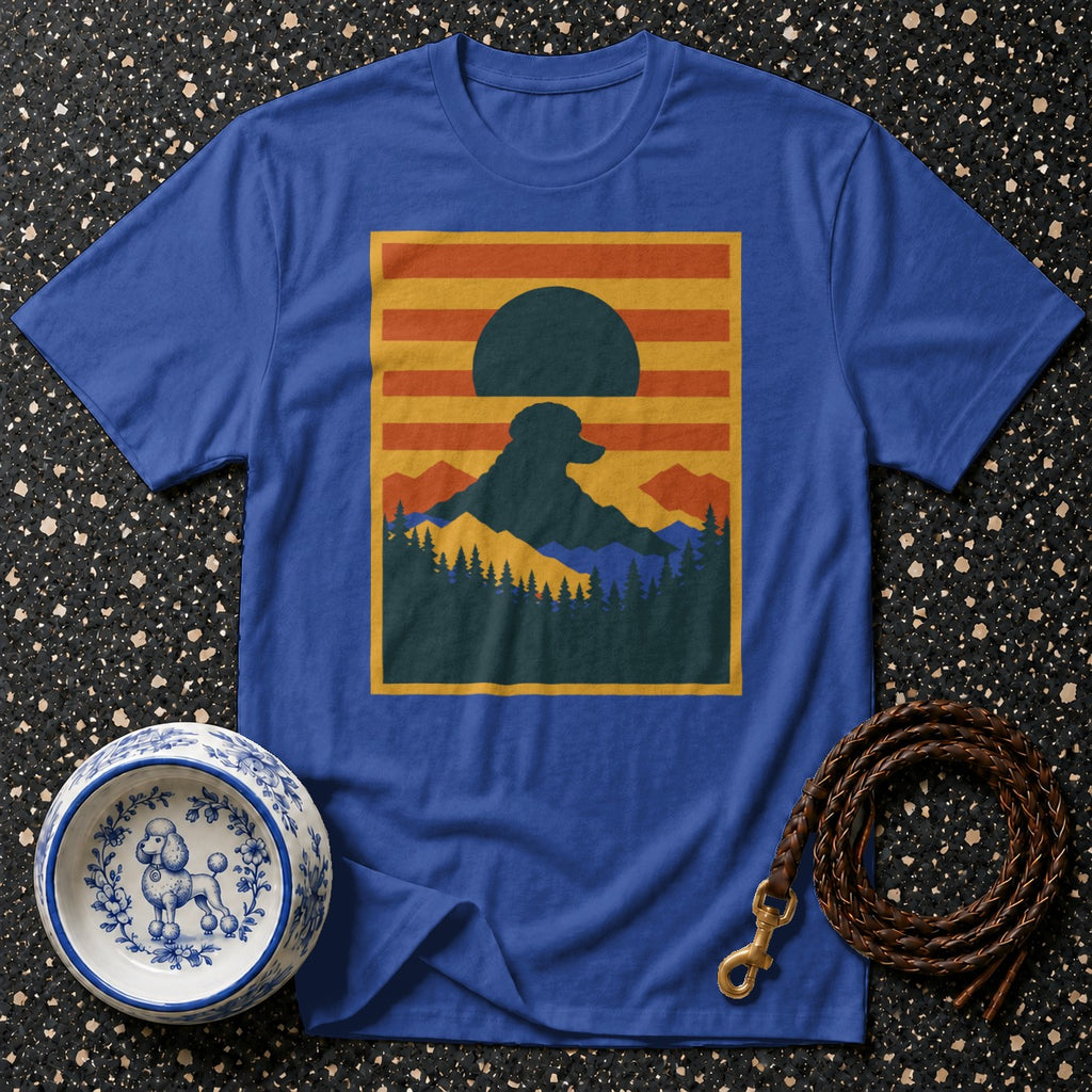Blue t-shirt with a graphic of a dog silhouette against a mountain sunset.