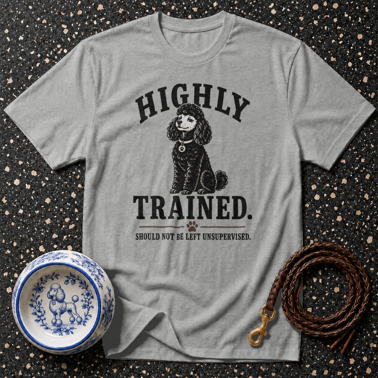 Grey t-shirt with "HIGHLY TRAINED. SHOULD NOT BE LEFT UNSUPERVISED." text and poodle graphic.