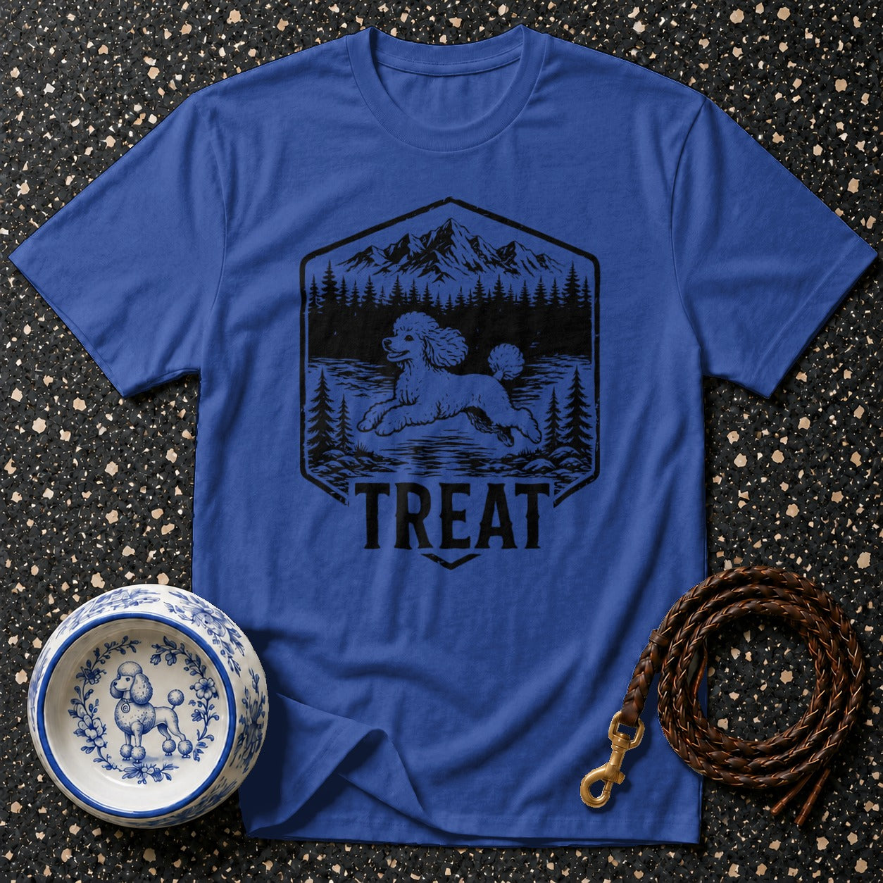 Royal blue t-shirt with black graphic of a poodle in a mountain landscape and the word "TREAT".