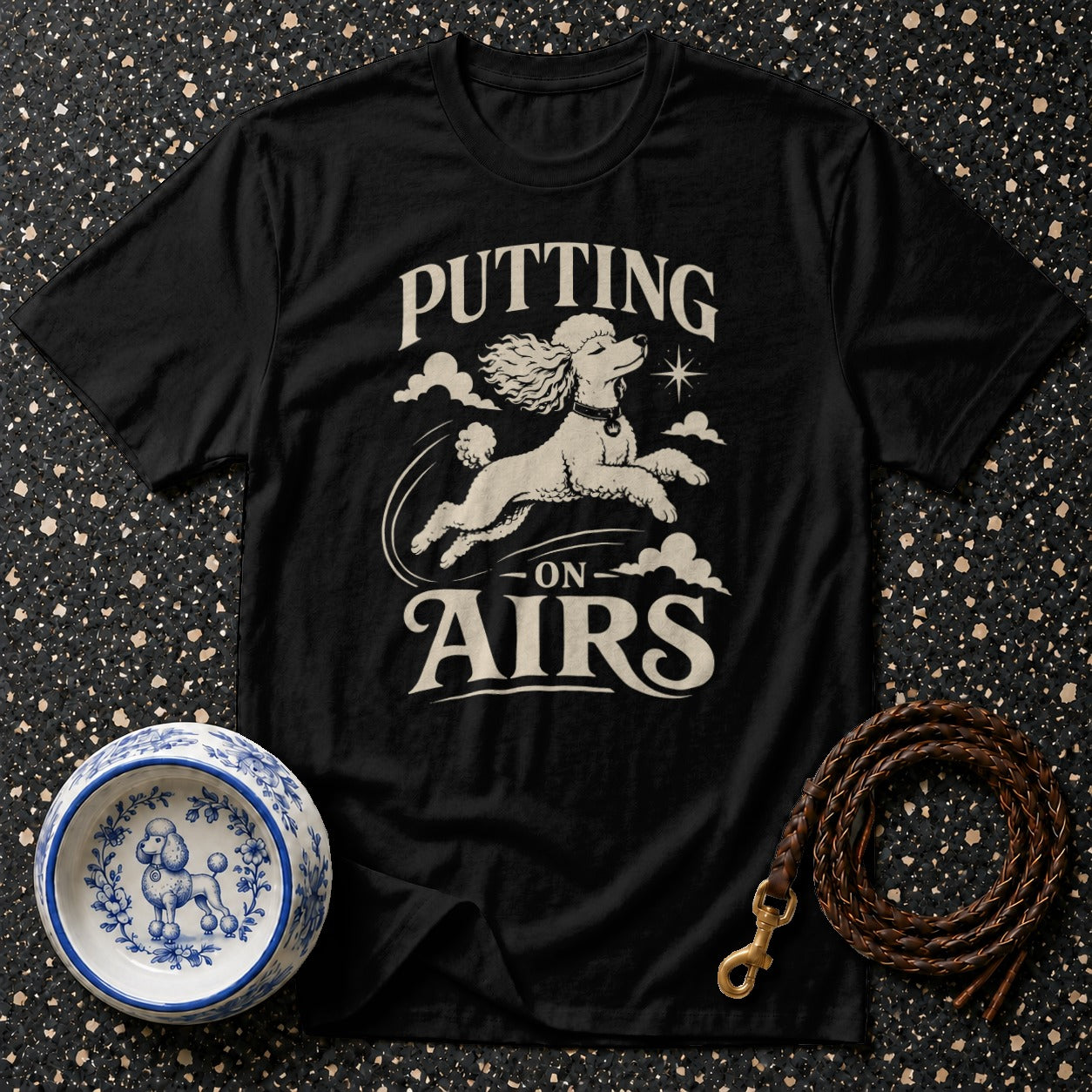 Black t-shirt with white poodle graphic and "Putting On Airs" text.