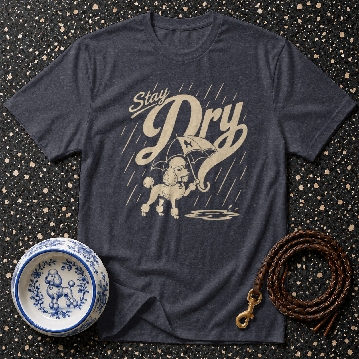 T-shirt with poodle under umbrella and "Stay Dry" text in beige.