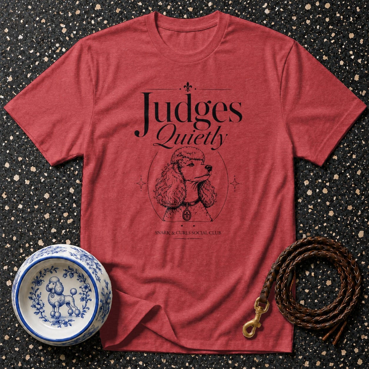 Red t-shirt with "Judges Quietly" and poodle graphic, dog bowl, and leash.