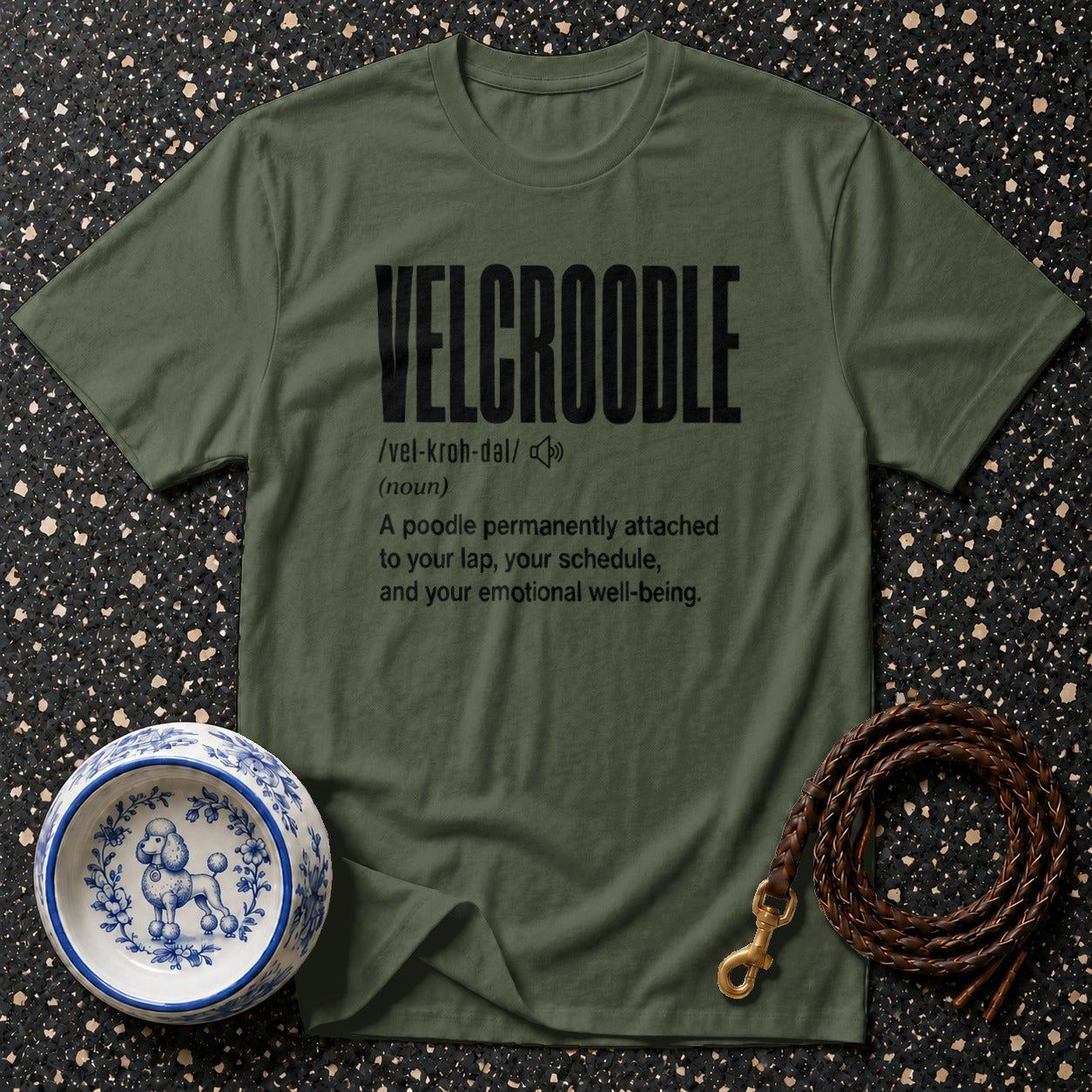 Green t-shirt with "VELCROODLE" definition, dog bowl, and leash.