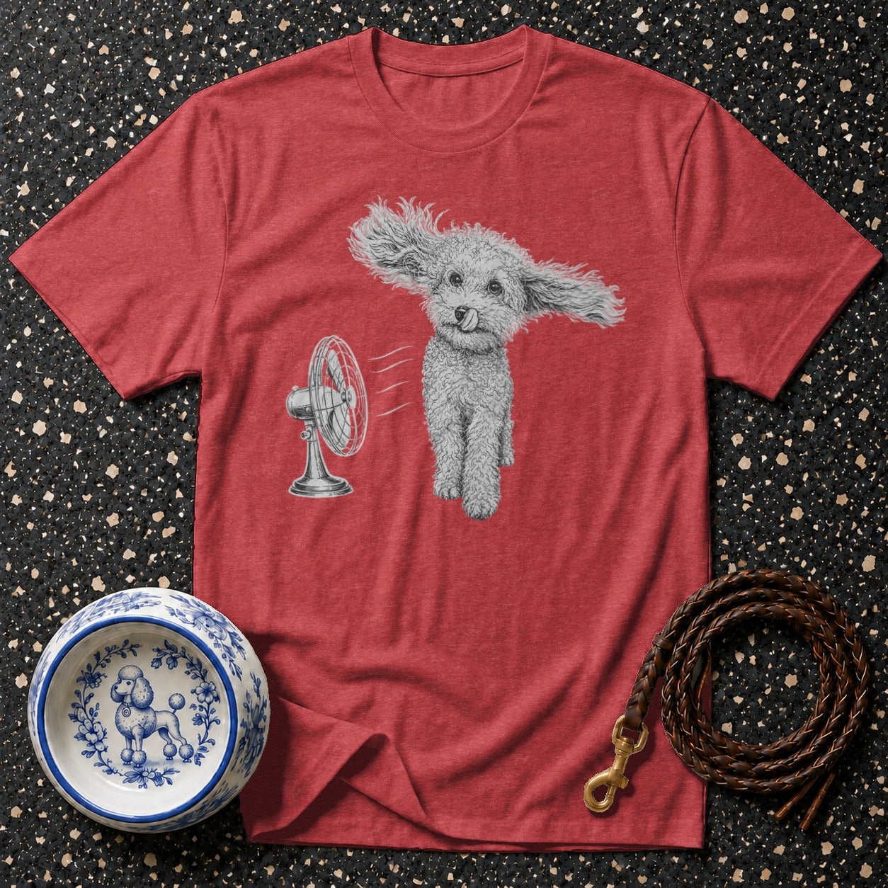 Red t-shirt with a sketched poodle and fan graphic, dog bowl, and leash.