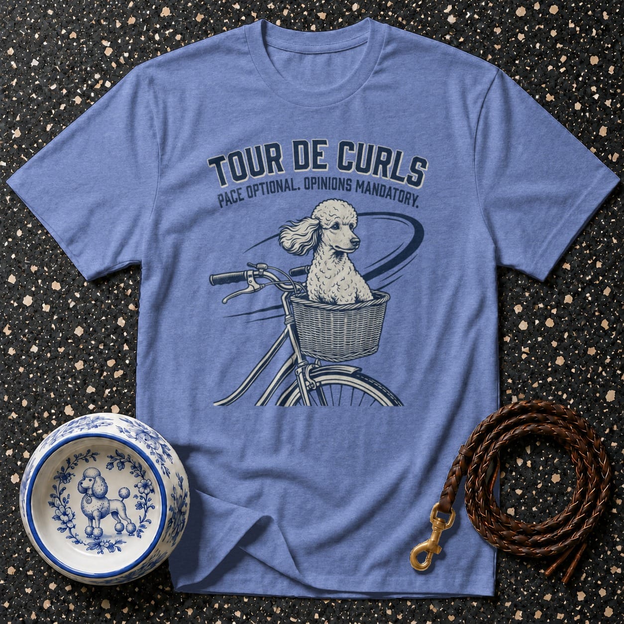 Light blue t-shirt with poodle in bicycle basket and text "Tour de Curls".