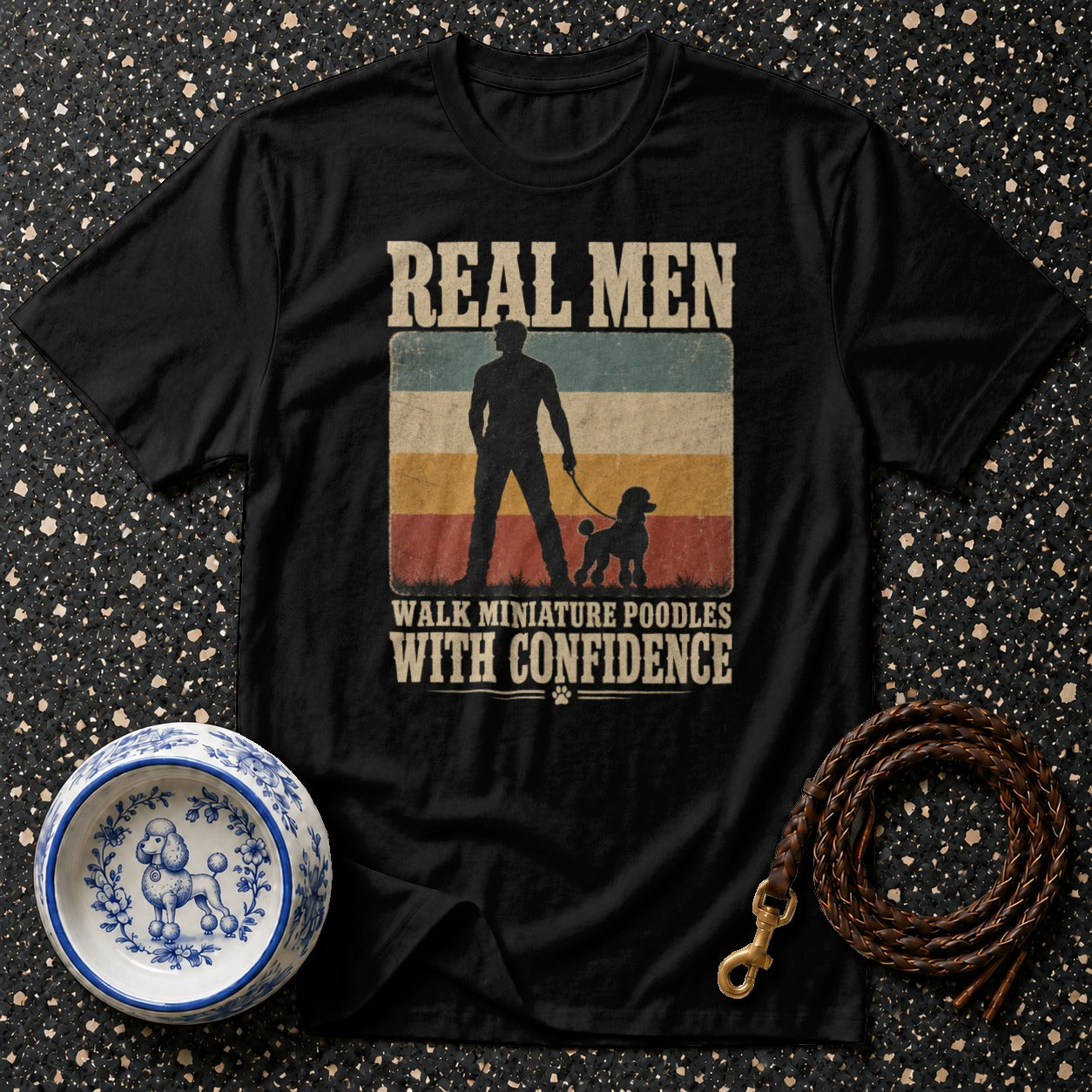 Black t-shirt with text "Real men walk miniature poodles with confidence."