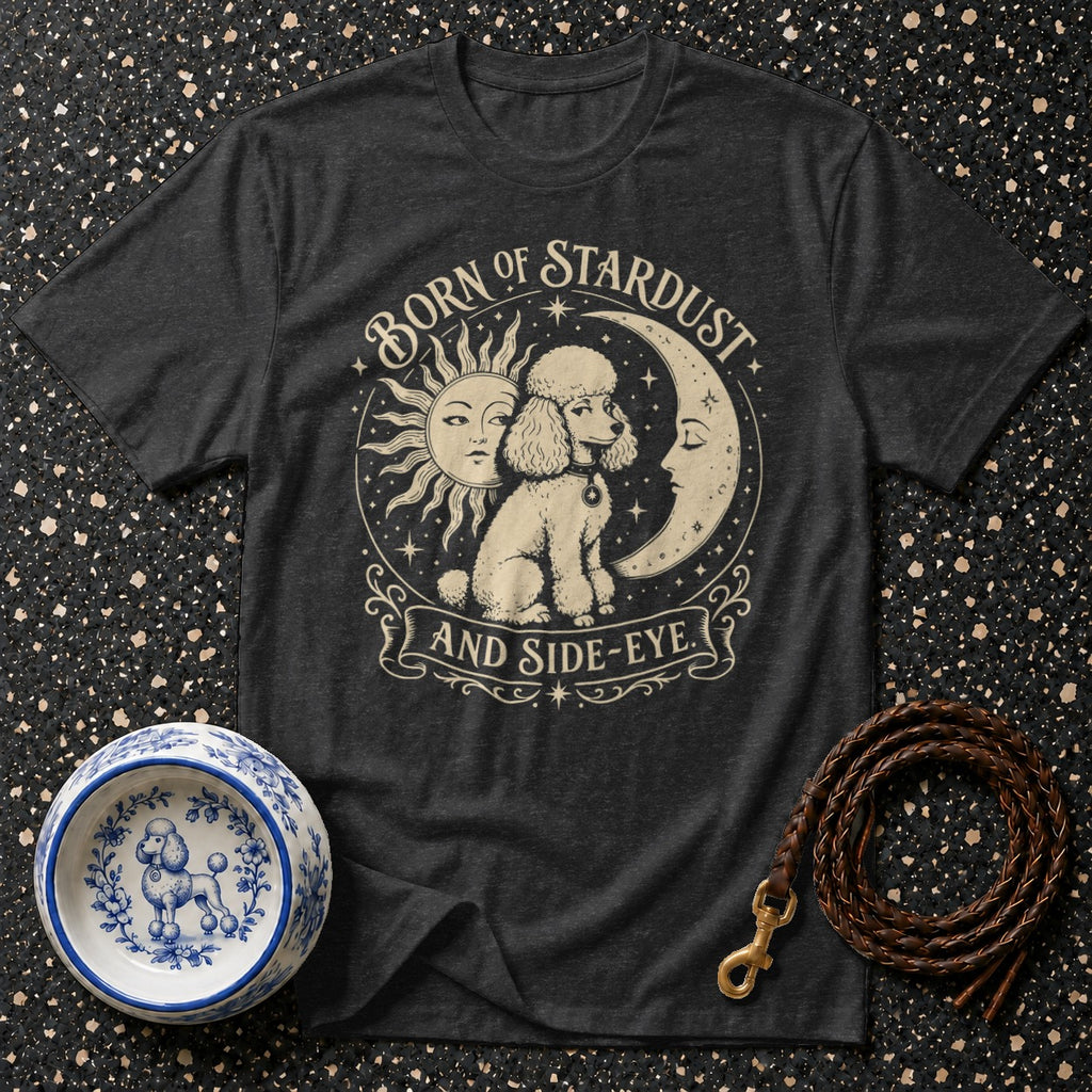 Dark t-shirt with poodle, sun, moon, and text "BORN OF STARDUST AND SIDE-EYE".