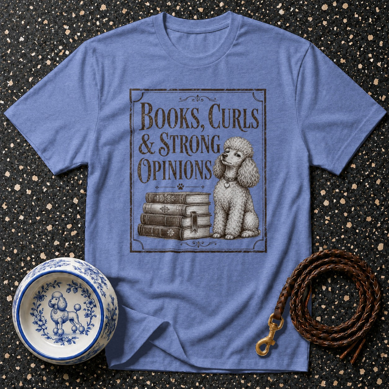 Blue t-shirt with vintage poodle illustration and text "Books, Curls & Strong Opinions."