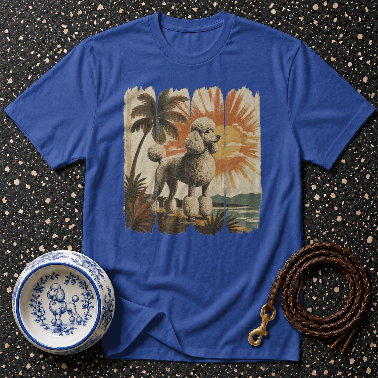 Blue t-shirt with vintage poodle and tropical sunset graphic.