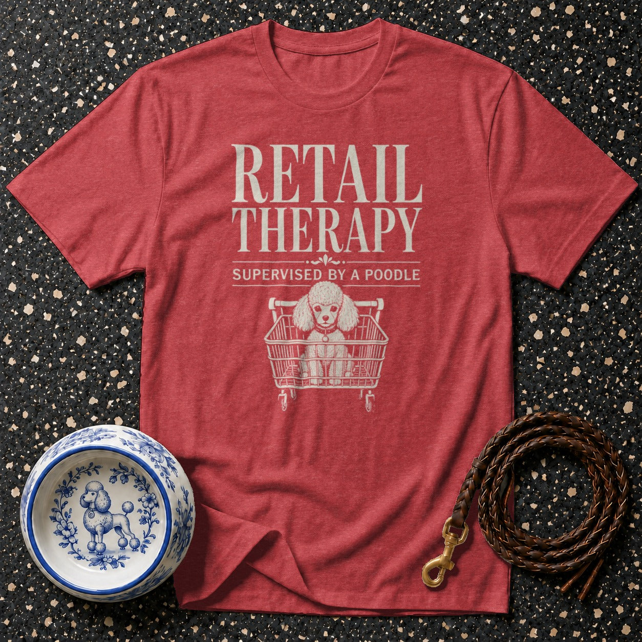 Red t-shirt with "Retail Therapy Supervised by a Poodle" text and poodle in shopping cart graphic.