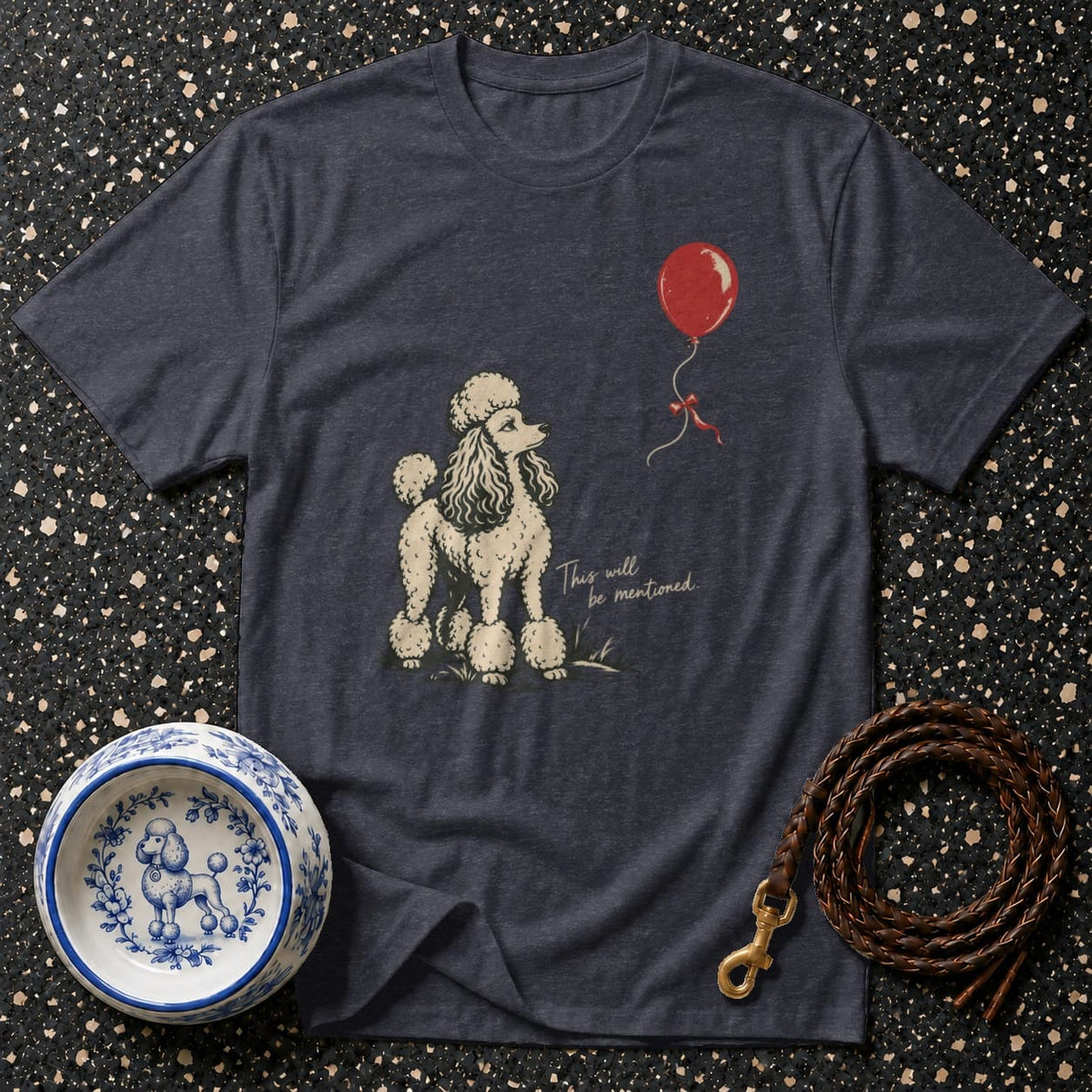 Dark grey t-shirt with poodle, red balloon, and text "This will be mentioned."